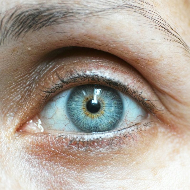 persons blue eyes in close up photography